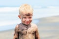 Happy dirty child having fun on black sand beach Royalty Free Stock Photo