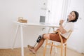 happy disability working women using prosthetics bionic leg enjoy work at home. asian female prosthetic limbs smiling