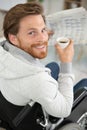 happy disable man having breakfast indoors