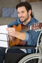 happy disable man playing guitar