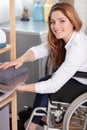happy disable woman doing laundry