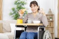 happy disable woman having breakfast at home