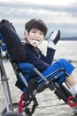 Happy disabled five year old boy in wheelchair