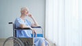 Happy disabled old female senior elderly patient woman on wheelchair in hospital ward room in medical and healthcare treatment Royalty Free Stock Photo