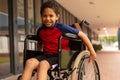 Happy disabled schoolboy looking at camera in corridor