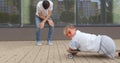 Disabled woman rides a skateboard during active funny games with happy man.