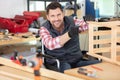 happy disabled worker in wheelchair in carpenters workshop Royalty Free Stock Photo