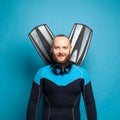 Happy diver diving man with flippers smiling against bright blue studio wall background Royalty Free Stock Photo