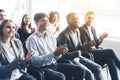 Happy diverse audience applauding at business seminar Royalty Free Stock Photo