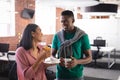 Happy diverse business colleagues on break, having coffee and snack in office Royalty Free Stock Photo