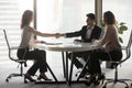 Happy diverse business partners handshaking at office meeting Royalty Free Stock Photo