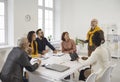 Happy diverse business team listening to a man during a work meeting in the office Royalty Free Stock Photo