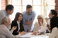 Happy diverse business team talking brainstorming gathered at table Royalty Free Stock Photo