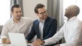 Happy diverse businessmen colleagues talking laughing at joke working together Royalty Free Stock Photo