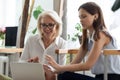 Smiling diverse female colleagues cooperate using laptop in office Royalty Free Stock Photo