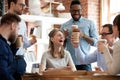 Happy diverse colleagues celebrate during lunch break in office