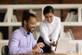 Happy diverse colleagues cooperate on computer in office Royalty Free Stock Photo
