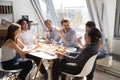 Happy diverse colleagues eating pizza during office work break Royalty Free Stock Photo