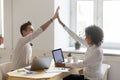 Happy diverse colleagues giving high five celebrating good teamw Royalty Free Stock Photo