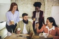 Diverse colleagues have fun at lunch break in office, smiling multiracial employees laugh and talk  drinking coffee Royalty Free Stock Photo