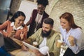 Diverse colleagues have fun at lunch break in office, smiling multiracial employees laugh and talk  drinking coffee Royalty Free Stock Photo