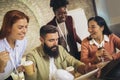 Diverse colleagues have fun at lunch break in office, smiling multiracial employees laugh and talk  drinking coffee Royalty Free Stock Photo