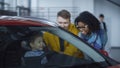 Happy diverse couple with kid testing car Royalty Free Stock Photo
