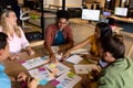 Happy diverse creative colleagues in discussion brainstorming using tablet and notes in office Royalty Free Stock Photo