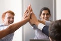 Happy diverse employees giving high five, celebrating success Royalty Free Stock Photo