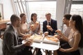 Happy diverse employees having fun, enjoying pizza together Royalty Free Stock Photo