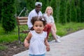 Happy diverse family with little daughter at park