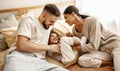 Happy diverse family mom, dad and child  laughing, playing and tickles   in bed   at home Royalty Free Stock Photo