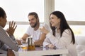 Happy diverse friends chatting in cafe, talking and laughing Royalty Free Stock Photo