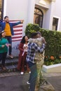 Happy diverse friends with flags welcoming home male soldier friend