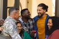 Happy diverse friends with flags welcoming home male soldier friend