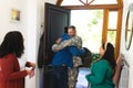 Happy diverse friends with flags welcoming home male soldier friend