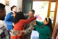 Happy diverse friends with flags welcoming home male soldier friend