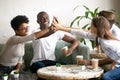 Happy diverse friends giving high five together in cafe Royalty Free Stock Photo