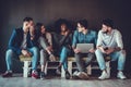 Happy diverse friends group sharing social media app news sitting holding phones, smiling multiracial young people students Royalty Free Stock Photo