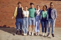 Group of happy cheerful diverse friends meet up on city streets and have fun together Royalty Free Stock Photo