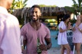 Happy diverse friends having party at beach, drinking cocktails and beer Royalty Free Stock Photo