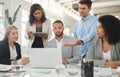 Happy diverse group of businesspeople having a meeting while standing together at a table at work. Business Royalty Free Stock Photo