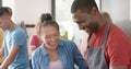 Happy diverse group of friends preapring meal in kitchen, slow motion