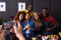 Happy diverse group of friends taking photo with smartphone in kitchen Royalty Free Stock Photo