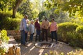 Happy diverse group of senior friends standing and smiling in sunny garden Royalty Free Stock Photo