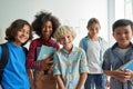 Happy diverse junior school students children looking at camera in classroom. Royalty Free Stock Photo