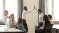 Happy diverse employees giving high five together celebrating shared win Royalty Free Stock Photo