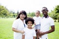 Happy diverse and mixed race family group photo in the park Royalty Free Stock Photo