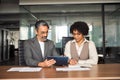 Happy diverse professional business team talking working in office using tablet. Royalty Free Stock Photo