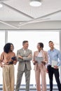 Happy diverse professional team leaders standing in office, vertical. Royalty Free Stock Photo
